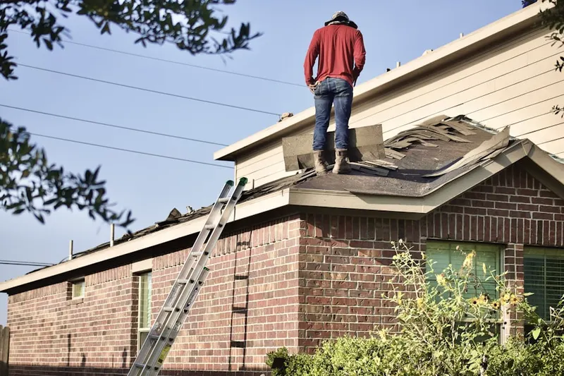 Professional roofer working on a residential roof in Ganymede